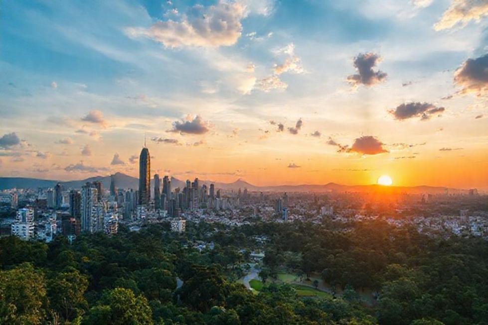 A breathtaking sunset over Belo Horizonte, showcasing the city's skyline with nature.