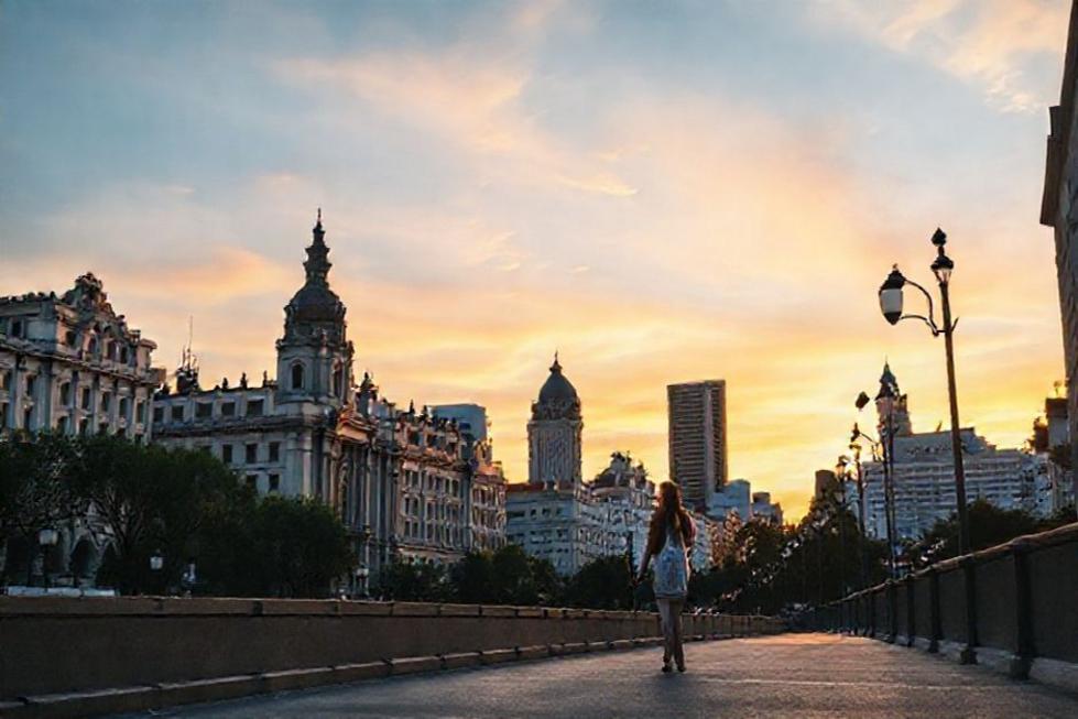 Casal caminhando em uma rua de Buenos Aires durante o pôr do sol.